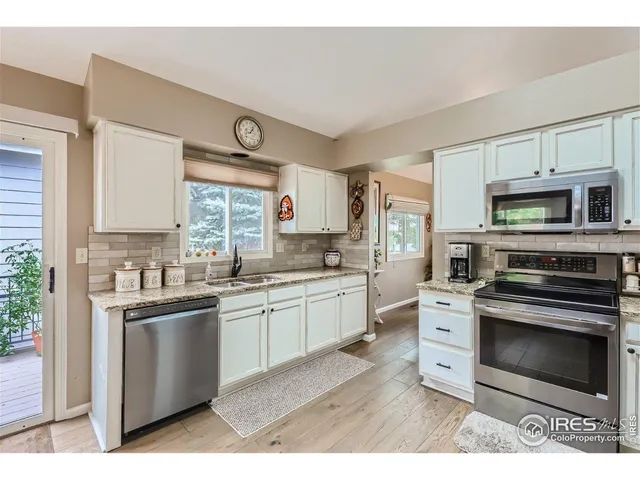 a kitchen with stainless steel appliances granite countertop a stove sink and microwave