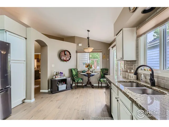 a kitchen with a refrigerator and a sink