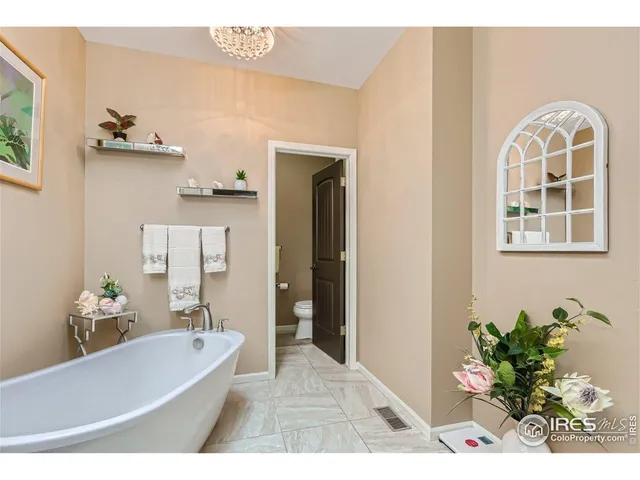 a en suite bathroom with a granite countertop sink mirror and bathtub