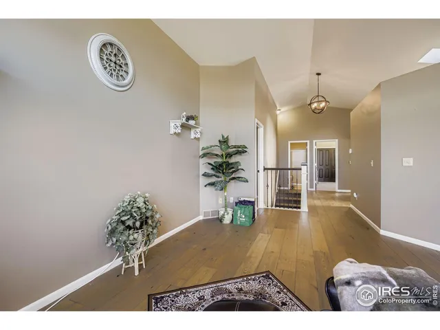 a view of a livingroom with furniture window and wooden floor