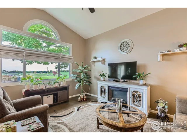 a work room with furniture and a floor to ceiling window