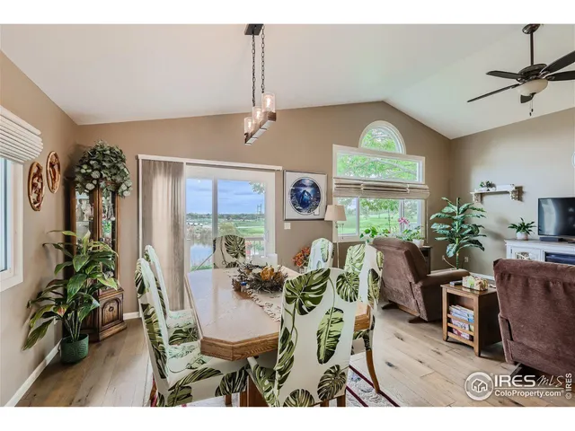 a dining room with furniture window and wooden floor