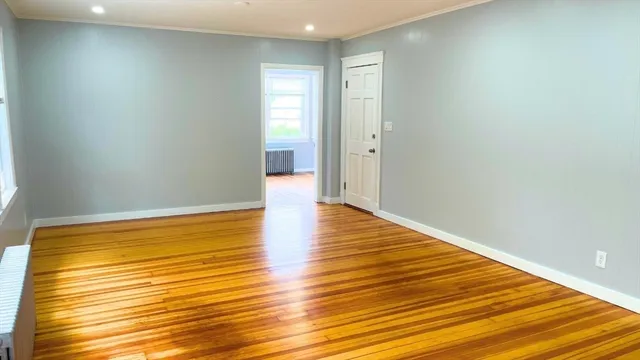 a view of a room with wooden floor