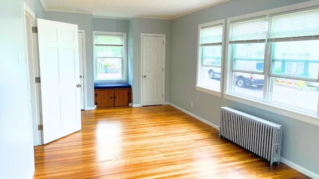 a view of a room with wooden floor and windows