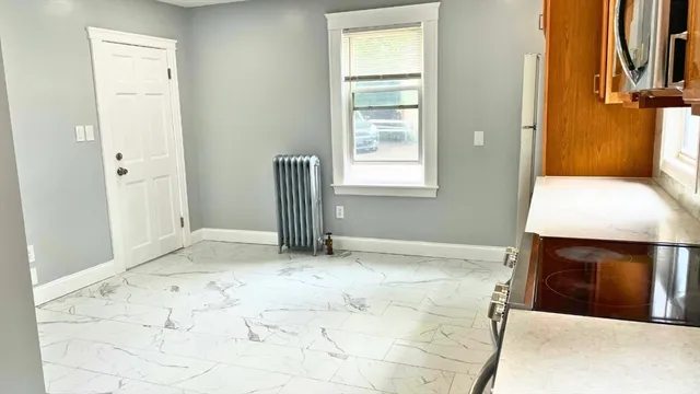 a view of an empty room with a fireplace