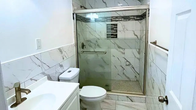 a bathroom with a toilet and shower