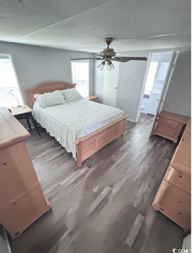 356 Calhoun Drive Murrells Inlet, SC 29576 - Photo 7 of 26 Bedroom featuring a textured ceiling, wood finished floors, and a ceiling fan