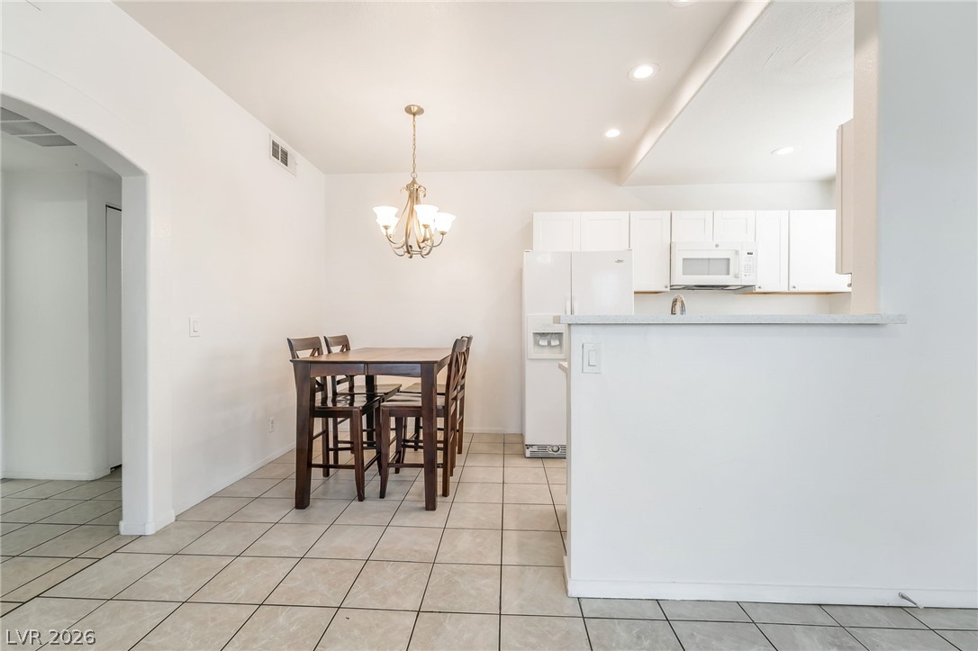 2201 Ramsgate Drive, Unit 811 Henderson, NV 89074 - Photo 10 of 36 A streamlined kitchen and dining area with contemporary appliances and practical tile flooring.