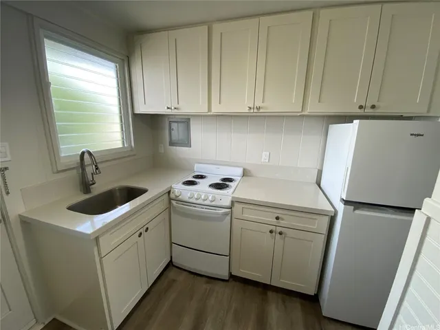a utility room with sink dryer and washer