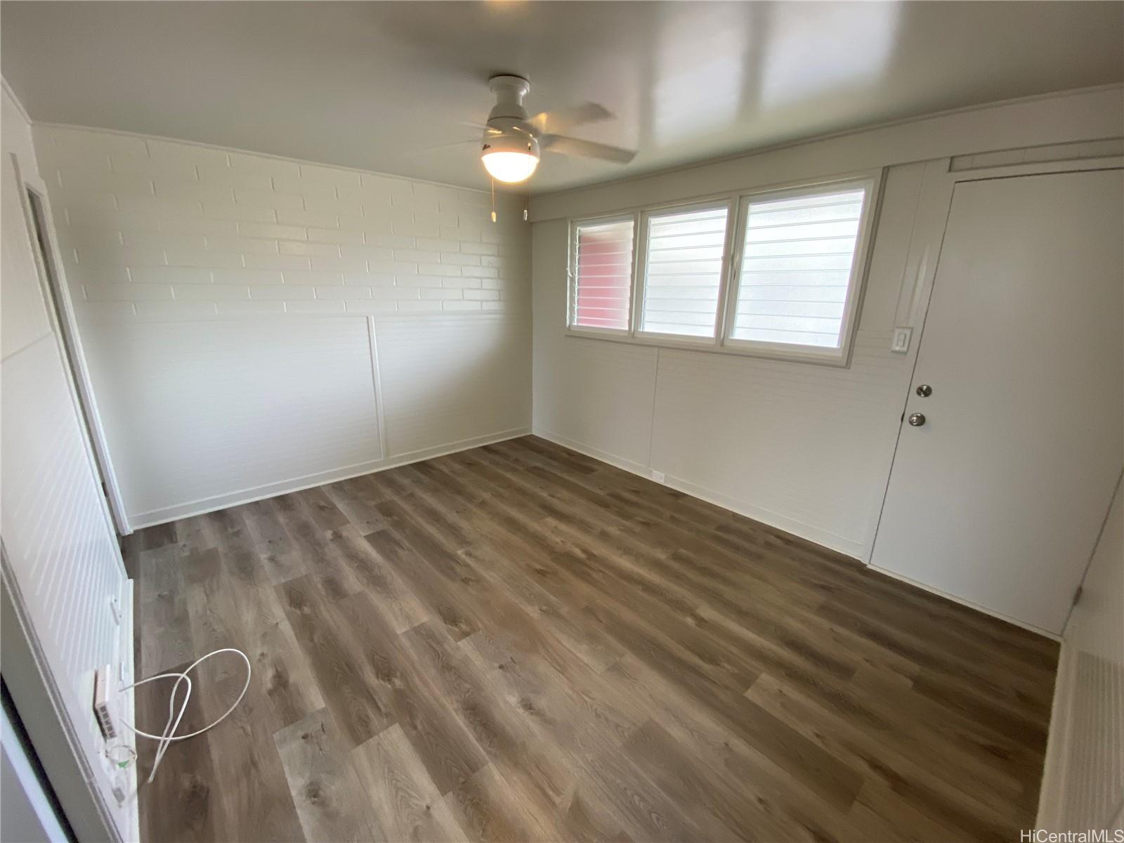 120 Kihapai Street, Unit 9 Kailua, HI 96734 - Photo 3 of 6 wooden floor in an empty room with a window