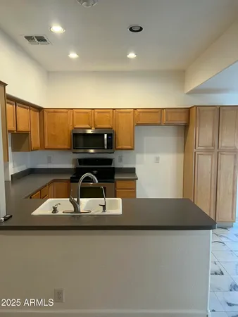 a kitchen with a sink and cabinets