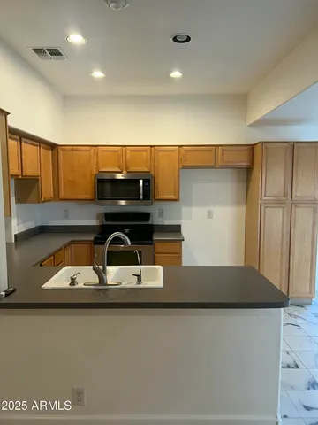 a kitchen with a sink and cabinets