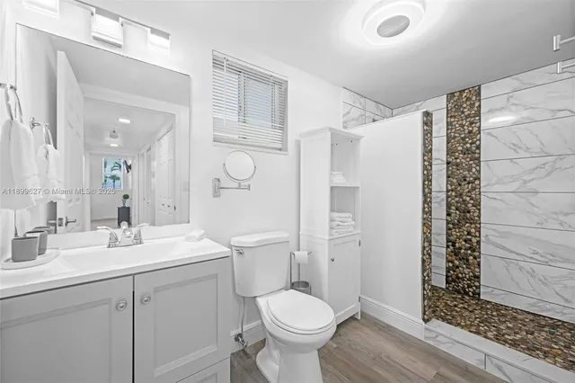 a bathroom with a sink toilet and shower