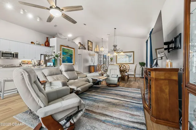 a living room with furniture a rug and white walls