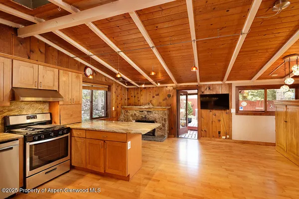 a kitchen with a sink and stove top oven