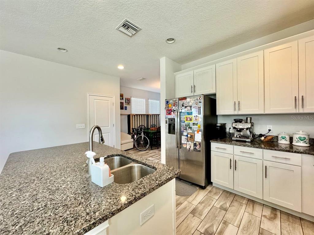2951 West Cherry Street Tampa, FL 33607 - Photo 11 of 25 a kitchen with stainless steel appliances granite countertop a sink a stove and refrigerator