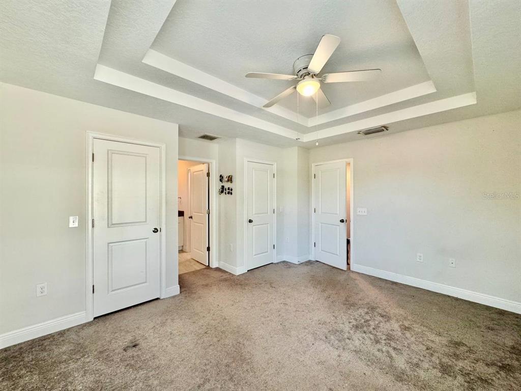 2951 West Cherry Street Tampa, FL 33607 - Photo 16 of 25 an empty room with a ceiling fan and closet area