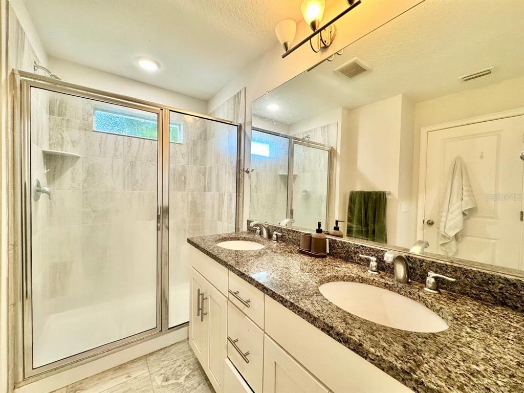 2951 West Cherry Street Tampa, FL 33607 - Photo 17 of 25 a bathroom with a granite countertop sink mirror and double