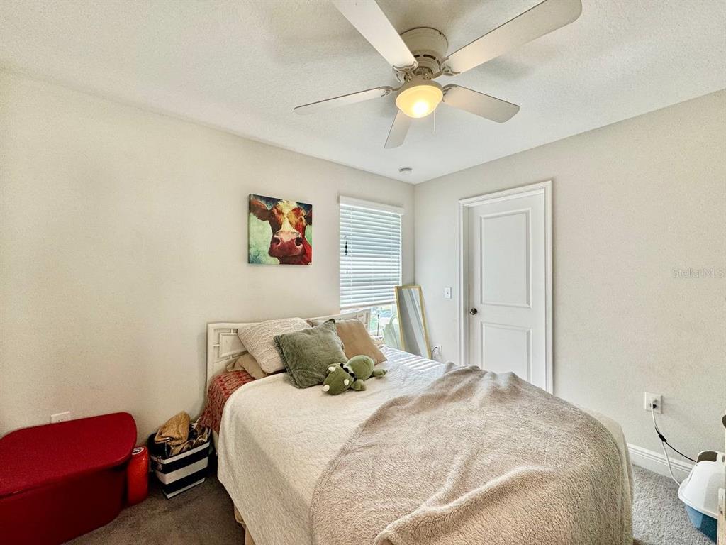 2951 West Cherry Street Tampa, FL 33607 - Photo 18 of 25 a bedroom with a bed and a chandelier
