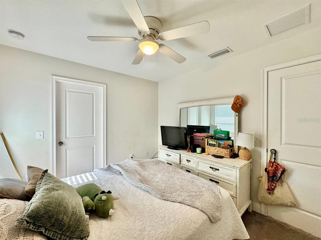 2951 West Cherry Street Tampa, FL 33607 - Photo 19 of 25 a bedroom with a bed and a chandelier