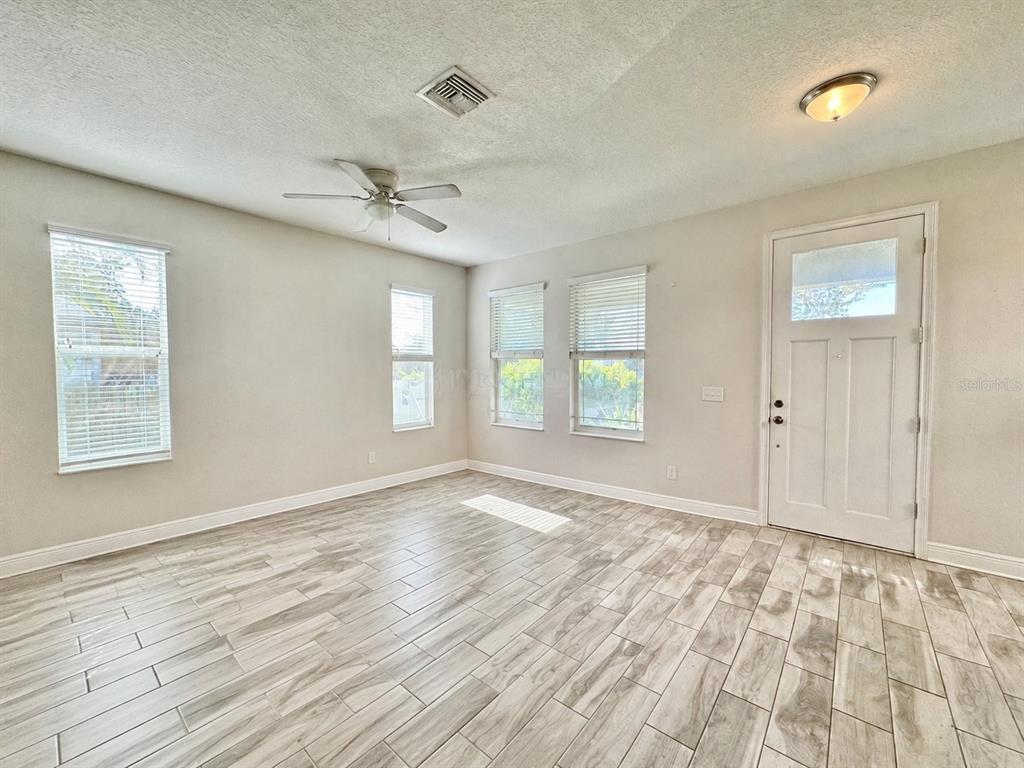 2951 West Cherry Street Tampa, FL 33607 - Photo 5 of 25 wooden floor in an empty room with a window