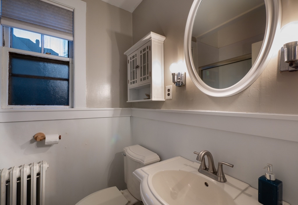 11 Wayne Street Boston, MA 02121 - Photo 14 of 27 a bathroom with a toilet sink and mirror