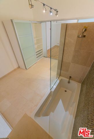a bathroom with a shower and a sink