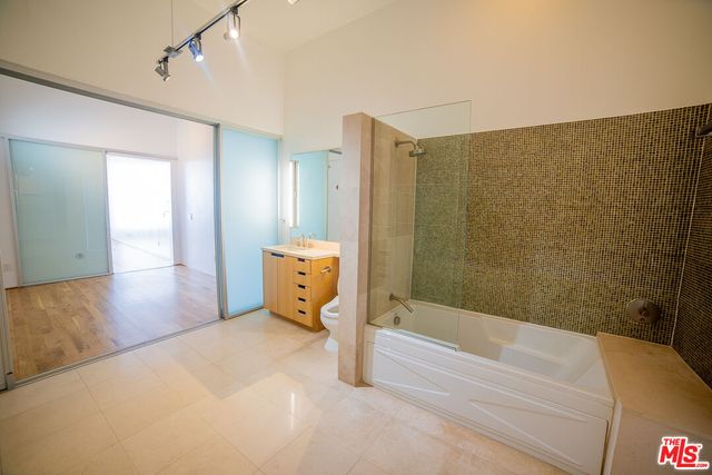 a bathroom with a bathtub and a shower