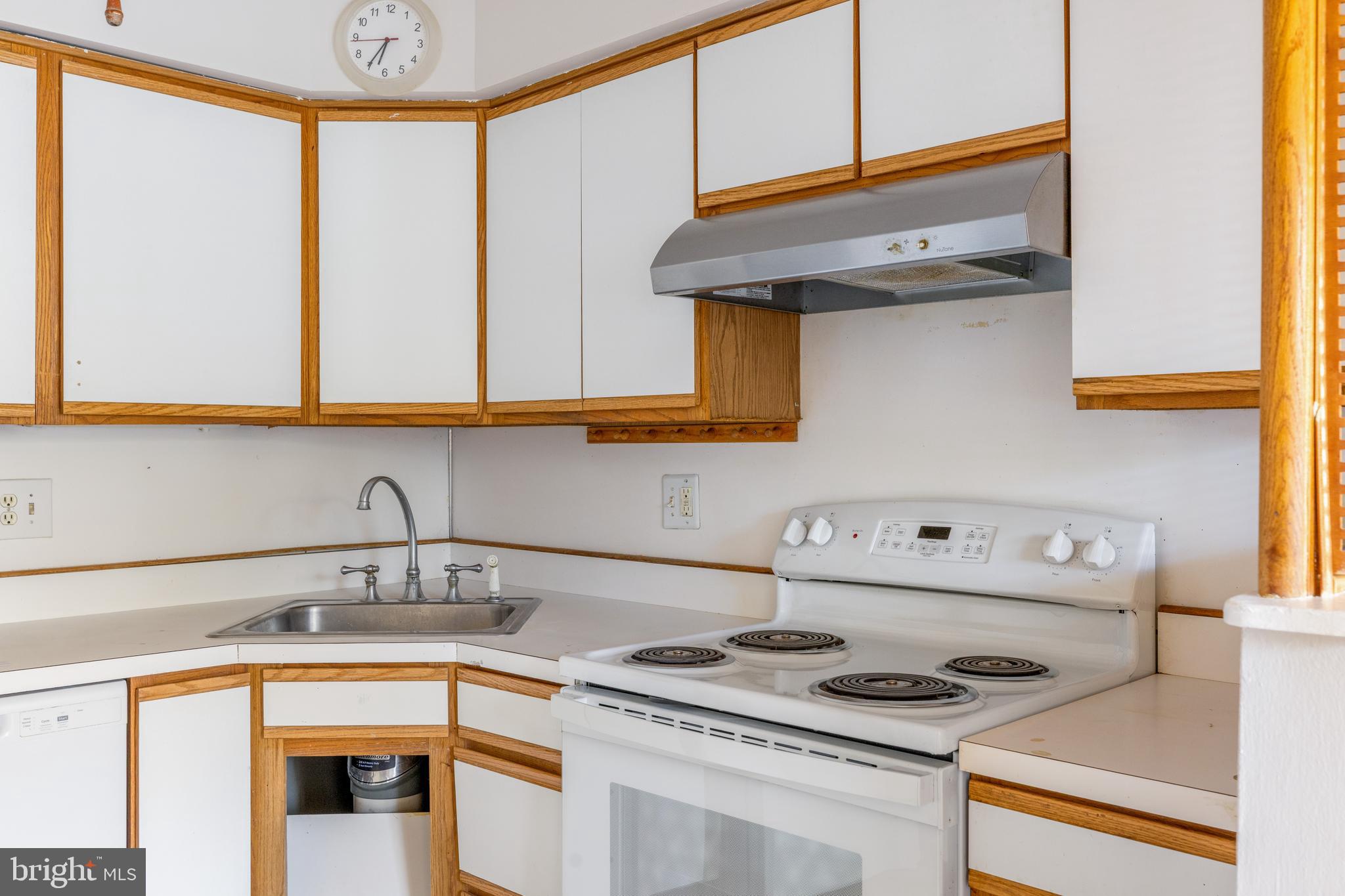 222 East Montgomery Avenue, Unit 207 Ardmore, PA 19003 - Photo 11 of 20 a kitchen with a stove and a white cabinet