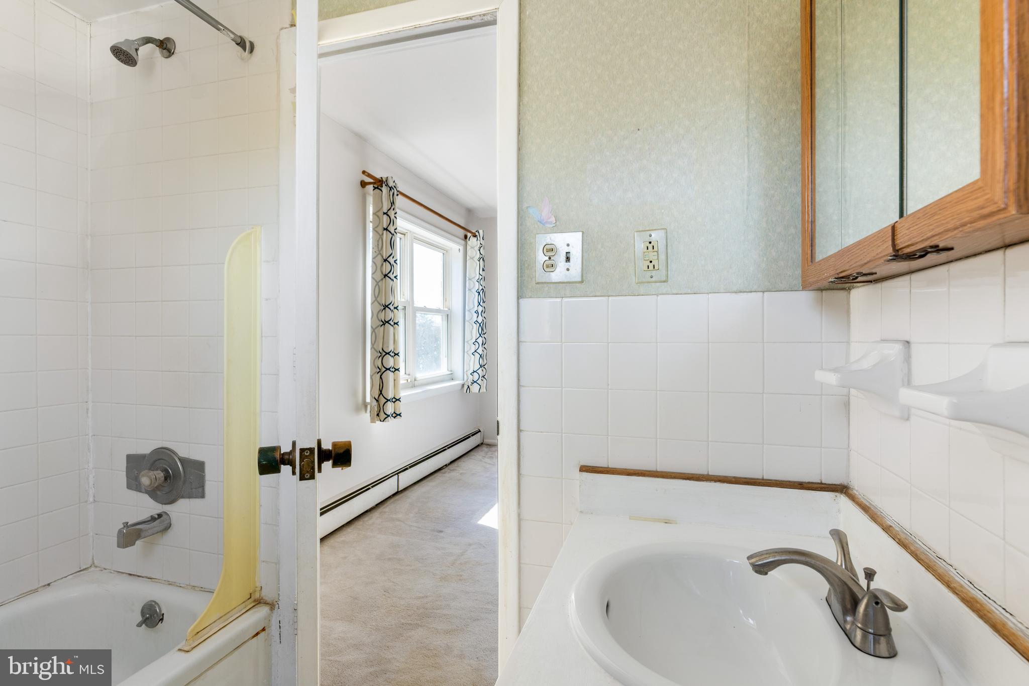 222 East Montgomery Avenue, Unit 207 Ardmore, PA 19003 - Photo 16 of 20 a bathroom with a tub a sink and a window
