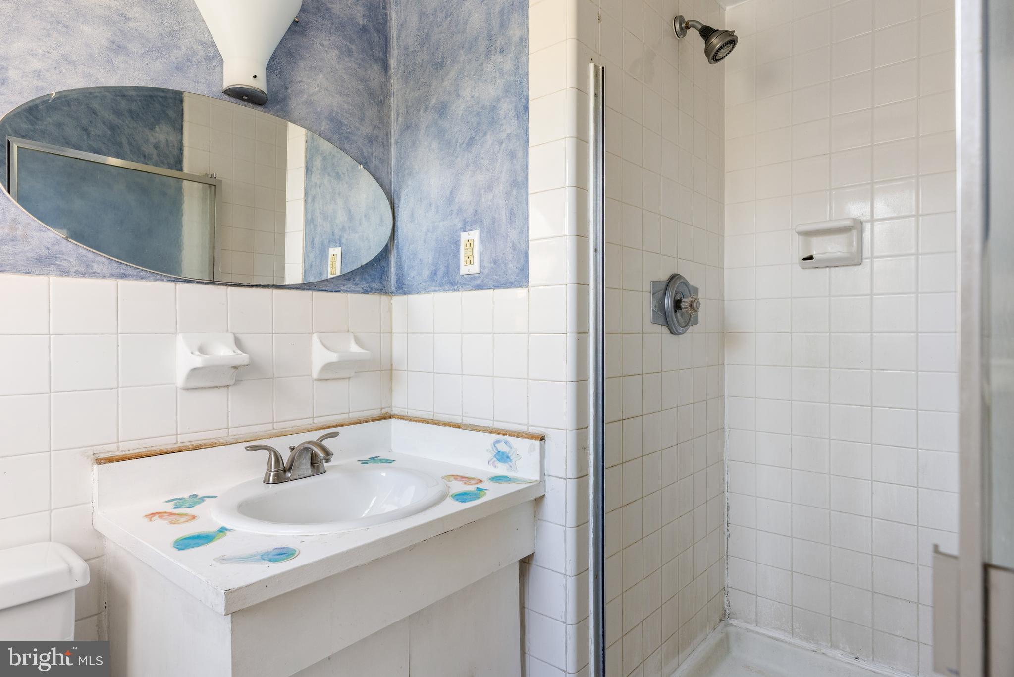 222 East Montgomery Avenue, Unit 207 Ardmore, PA 19003 - Photo 19 of 20 a bathroom with a sink and a mirror