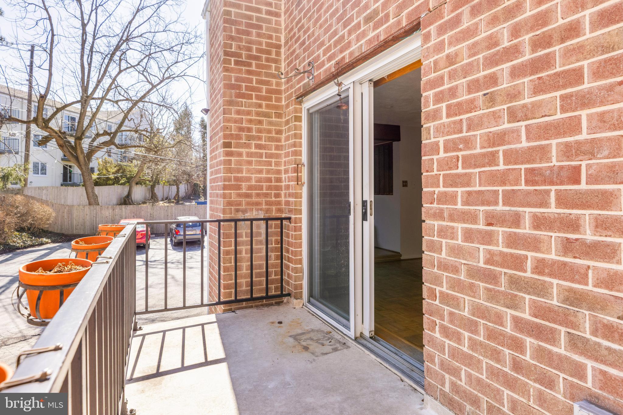 222 East Montgomery Avenue, Unit 207 Ardmore, PA 19003 - Photo 3 of 20 a view of a balcony with wooden floor and fence