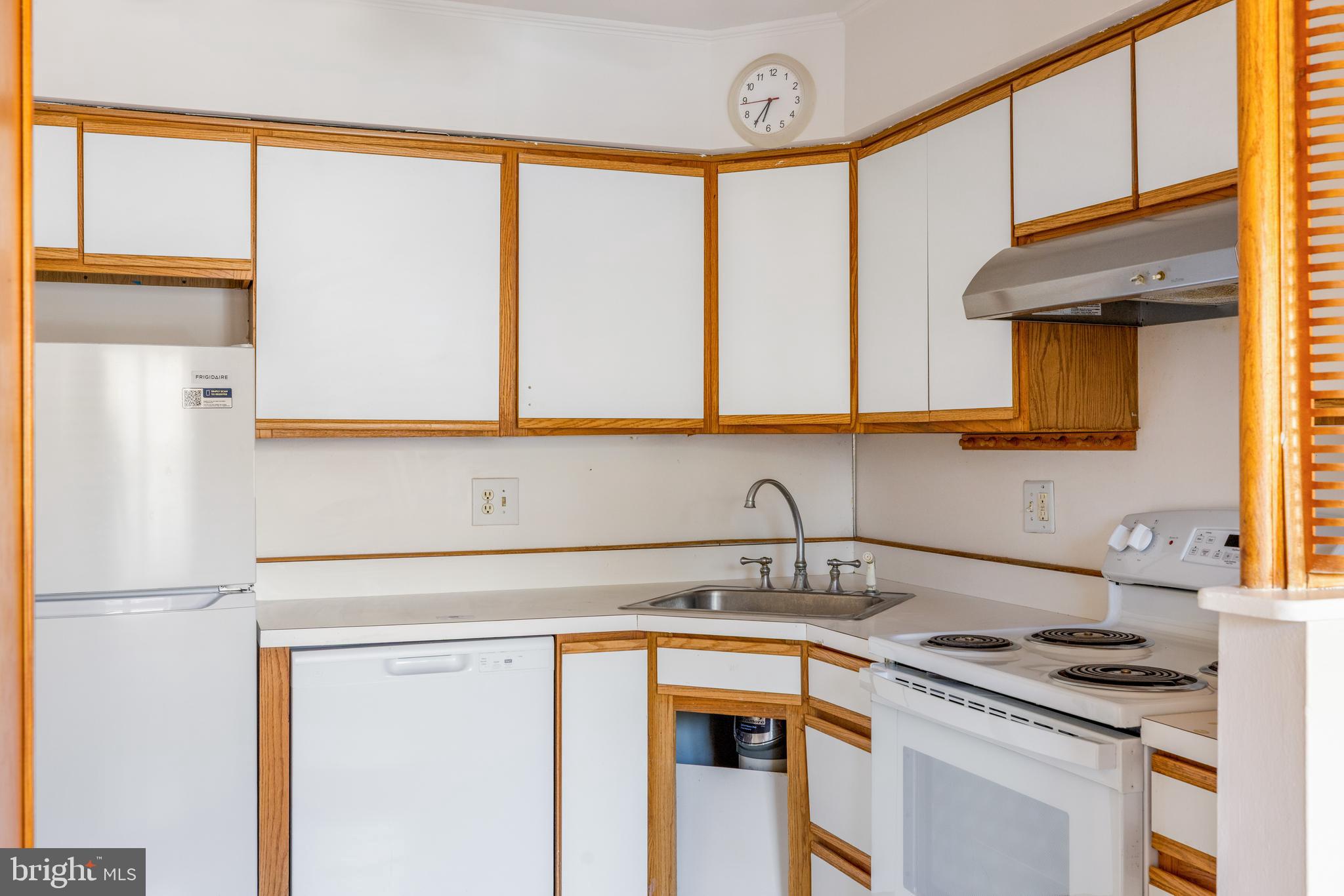 222 East Montgomery Avenue, Unit 207 Ardmore, PA 19003 - Photo 10 of 20 a kitchen with stainless steel appliances a sink a stove and a refrigerator
