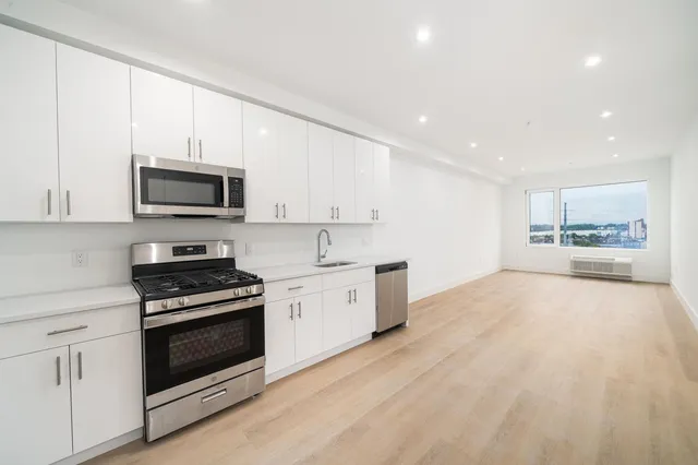 a large kitchen with a stove top oven and sink