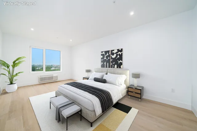 a bedroom with a bed and a window