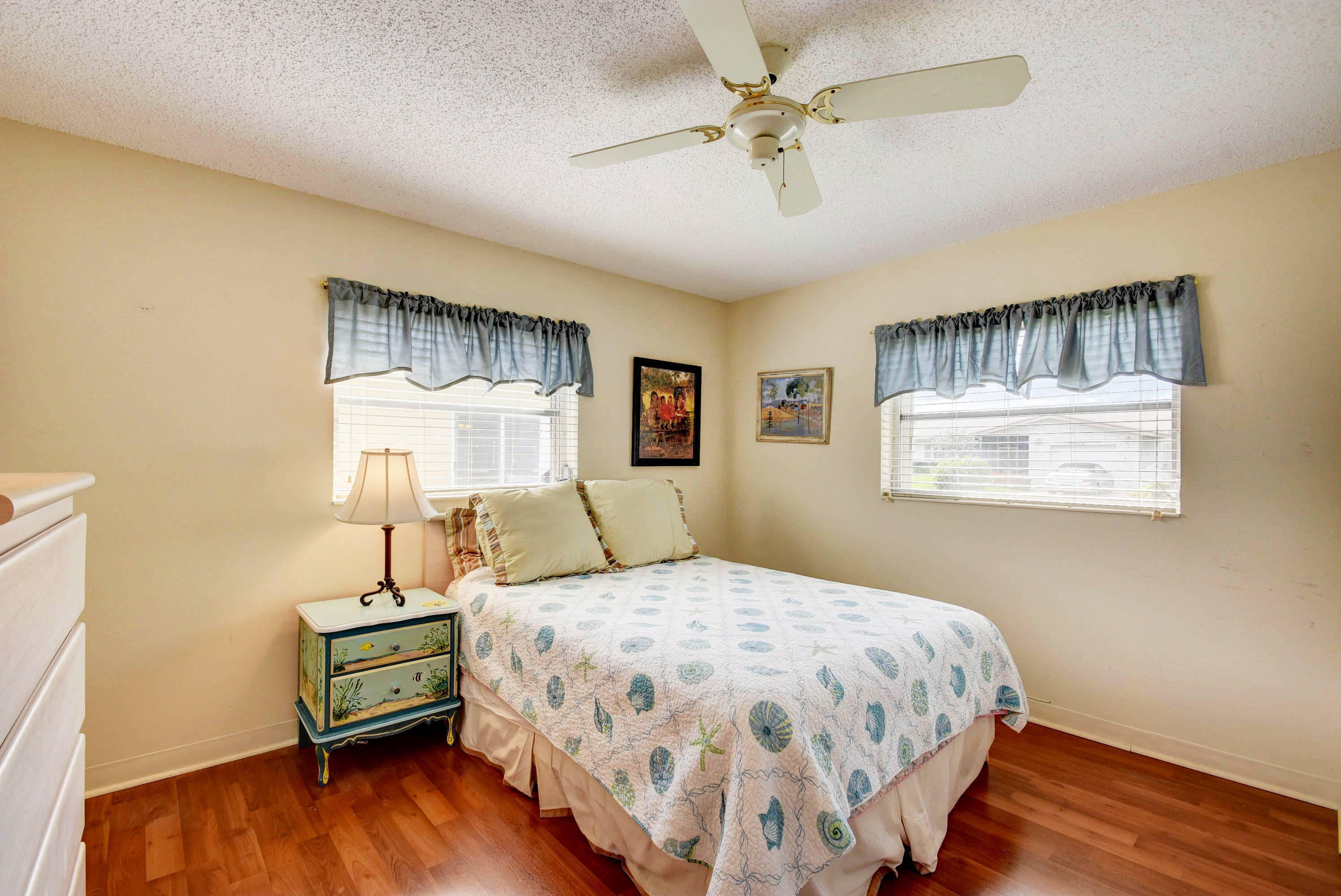 6295 Dusenburg Road Delray Beach, FL 33484 - Photo 21 of 34 a bedroom with a bed wooden floor and window