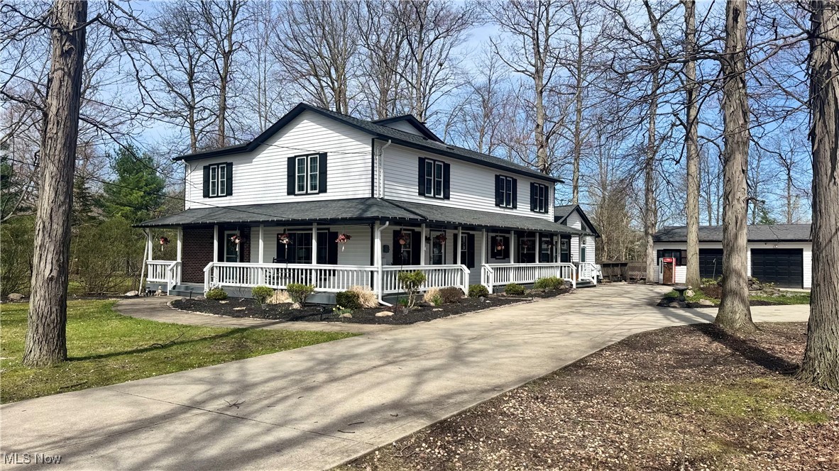 5927 Highland Road Highland Heights, OH 44143 - Photo 2 of 22 Country-style home featuring covered porch, an outdoor structure, concrete driveway, and a garage