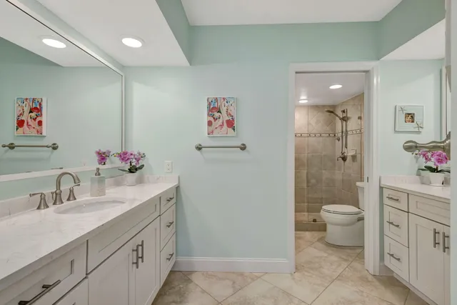 a kitchen with granite countertop a sink stainless steel appliances and cabinets