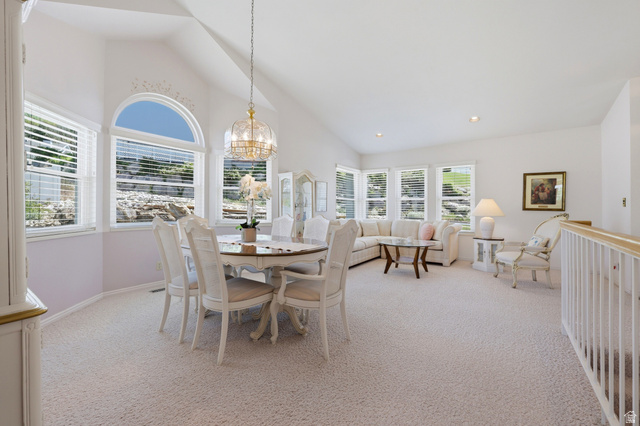 3766 Cardiff Circle Bountiful, UT 84010 - Photo 9 of 46 Vaulted ceiling with a central chandelier above a dining area, featuring a series of windows including an arched window