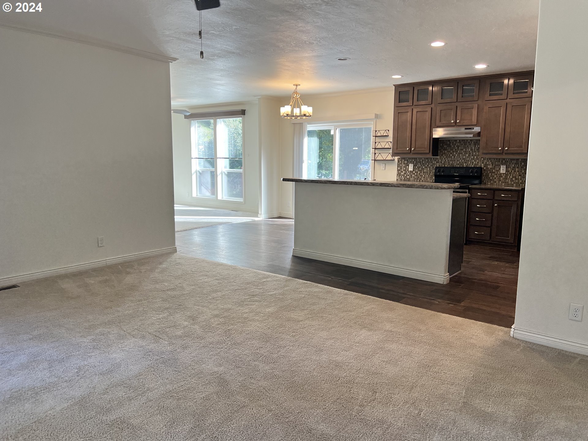 28312 Mateer Road Gold Beach, OR 97444 - Photo 11 of 25 an empty room with kitchen and windows