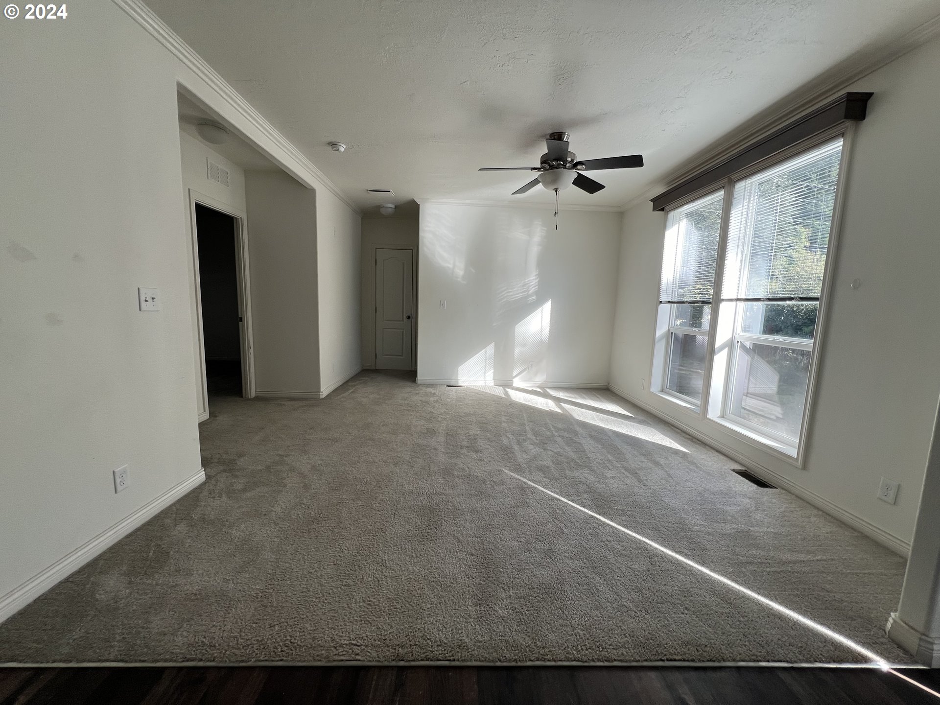28312 Mateer Road Gold Beach, OR 97444 - Photo 12 of 25 en empty room with windows and fan