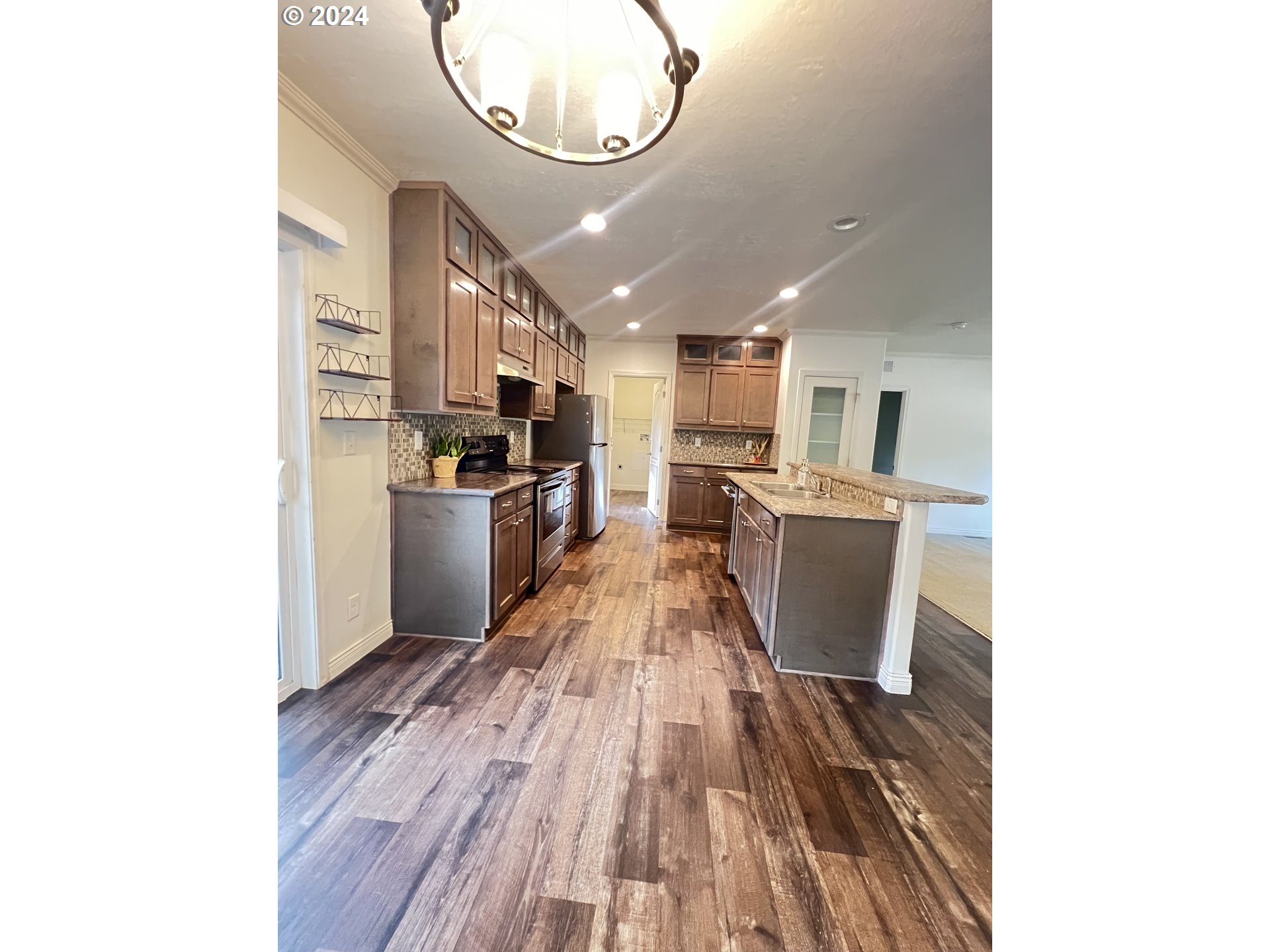 28312 Mateer Road Gold Beach, OR 97444 - Photo 20 of 25 a kitchen with granite countertop a stove a sink and a microwave