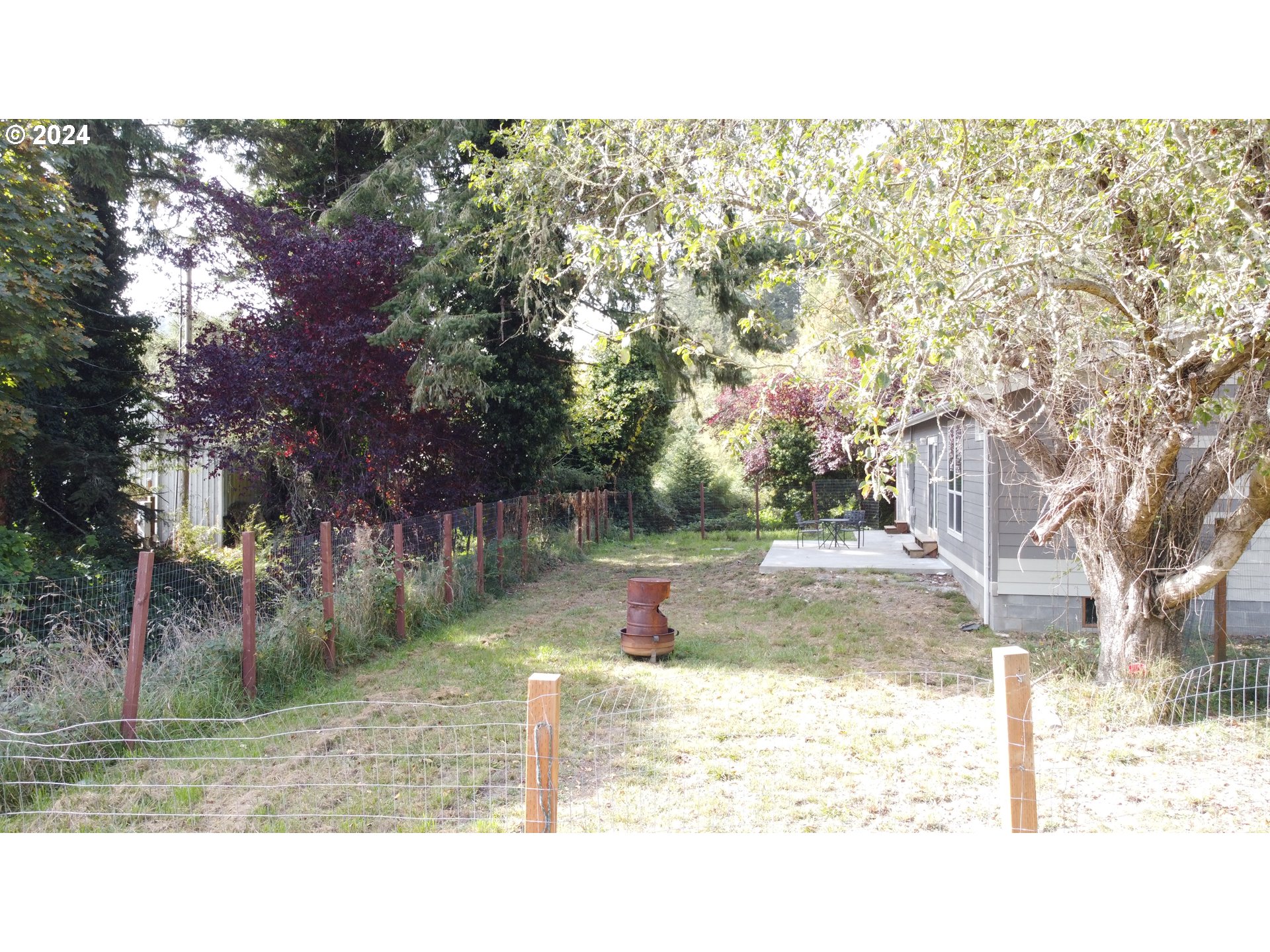 28312 Mateer Road Gold Beach, OR 97444 - Photo 23 of 25 a view of a yard in front of a house