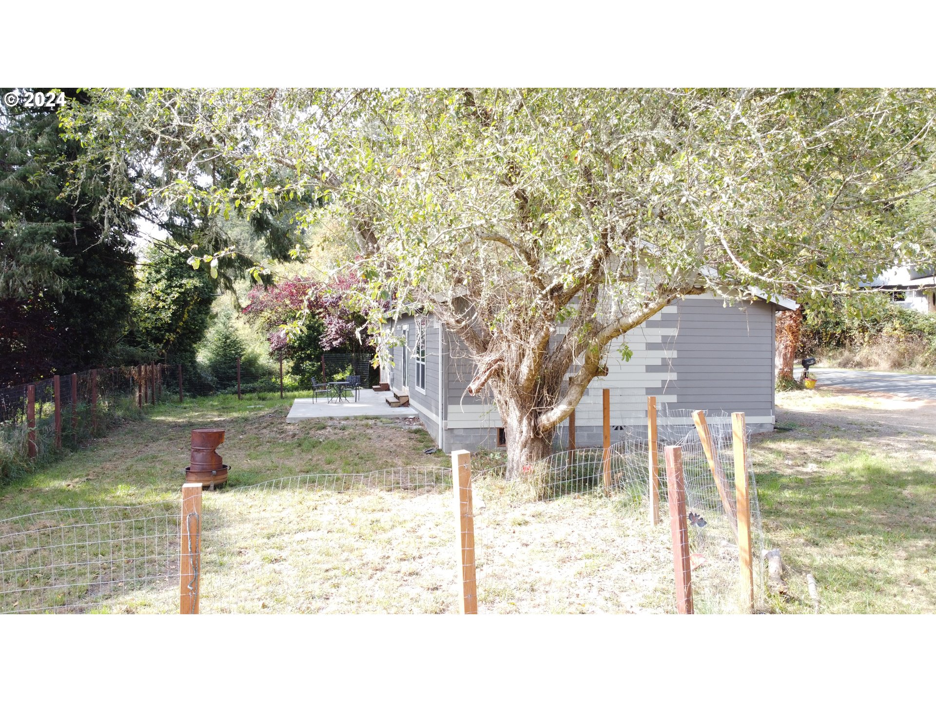 28312 Mateer Road Gold Beach, OR 97444 - Photo 24 of 25 a view of a yard in front of a house