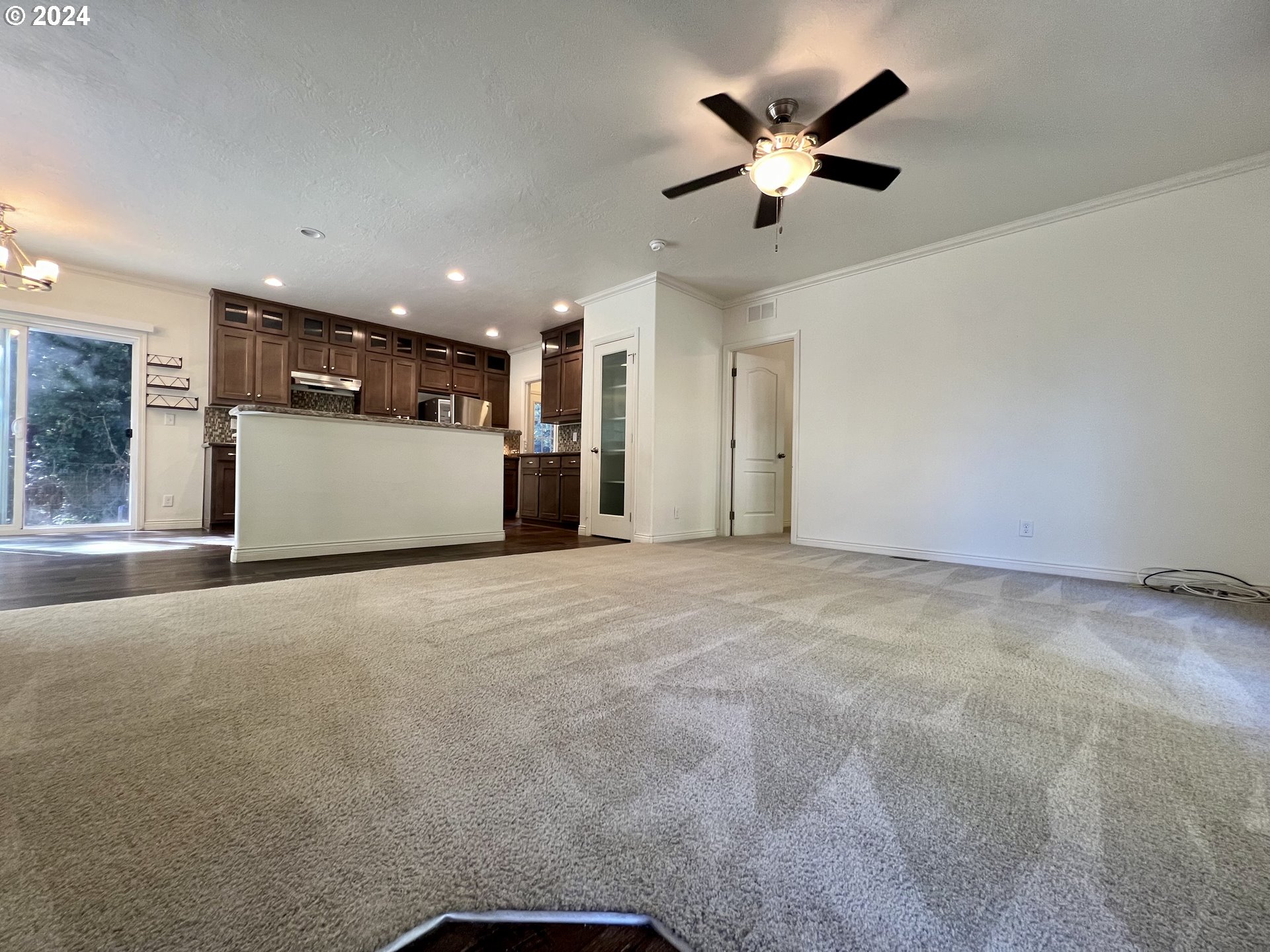 28312 Mateer Road Gold Beach, OR 97444 - Photo 4 of 25 a view of an empty room with a ceiling fan and window