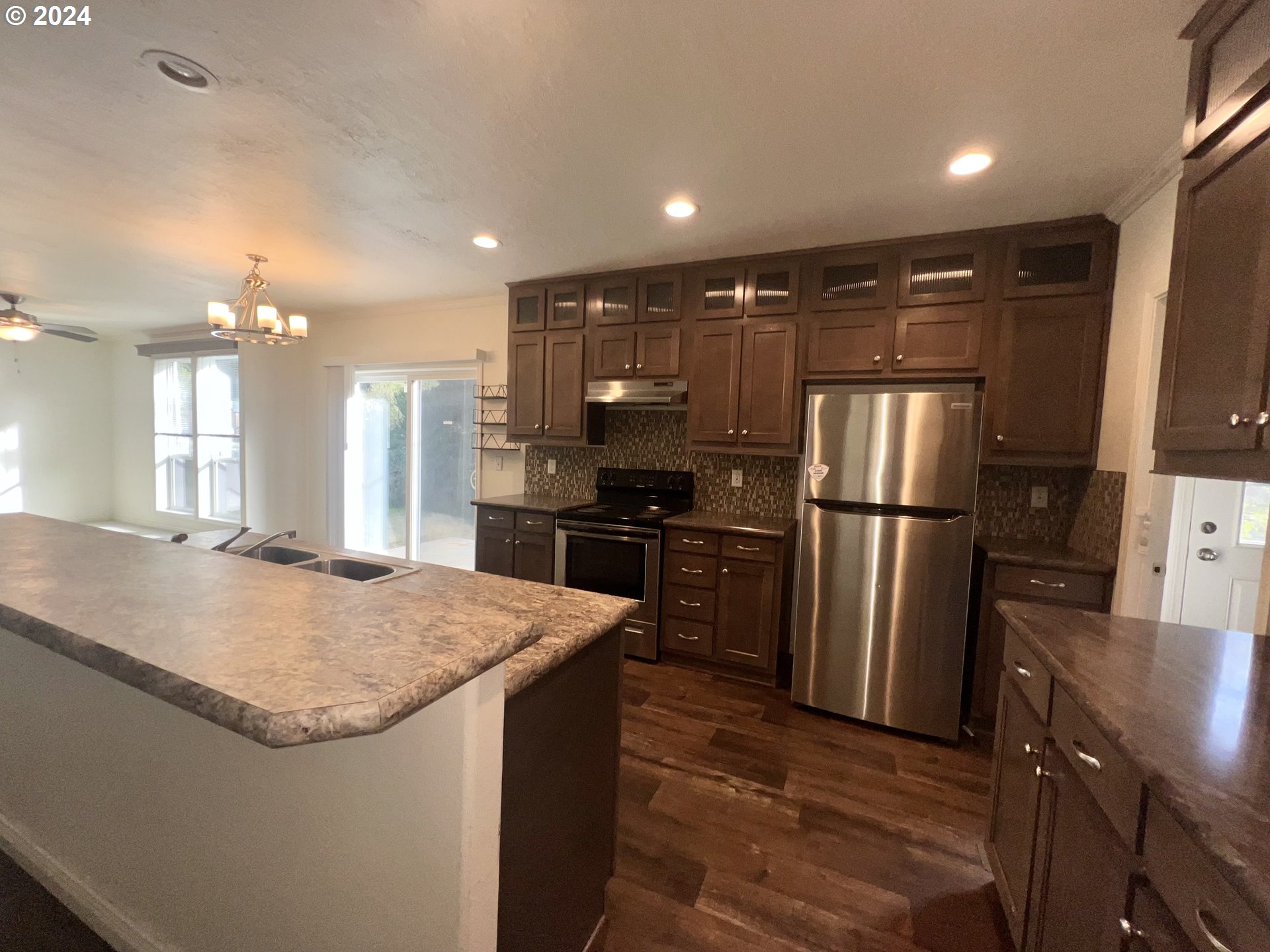 28312 Mateer Road Gold Beach, OR 97444 - Photo 5 of 25 a kitchen with refrigerator and chairs