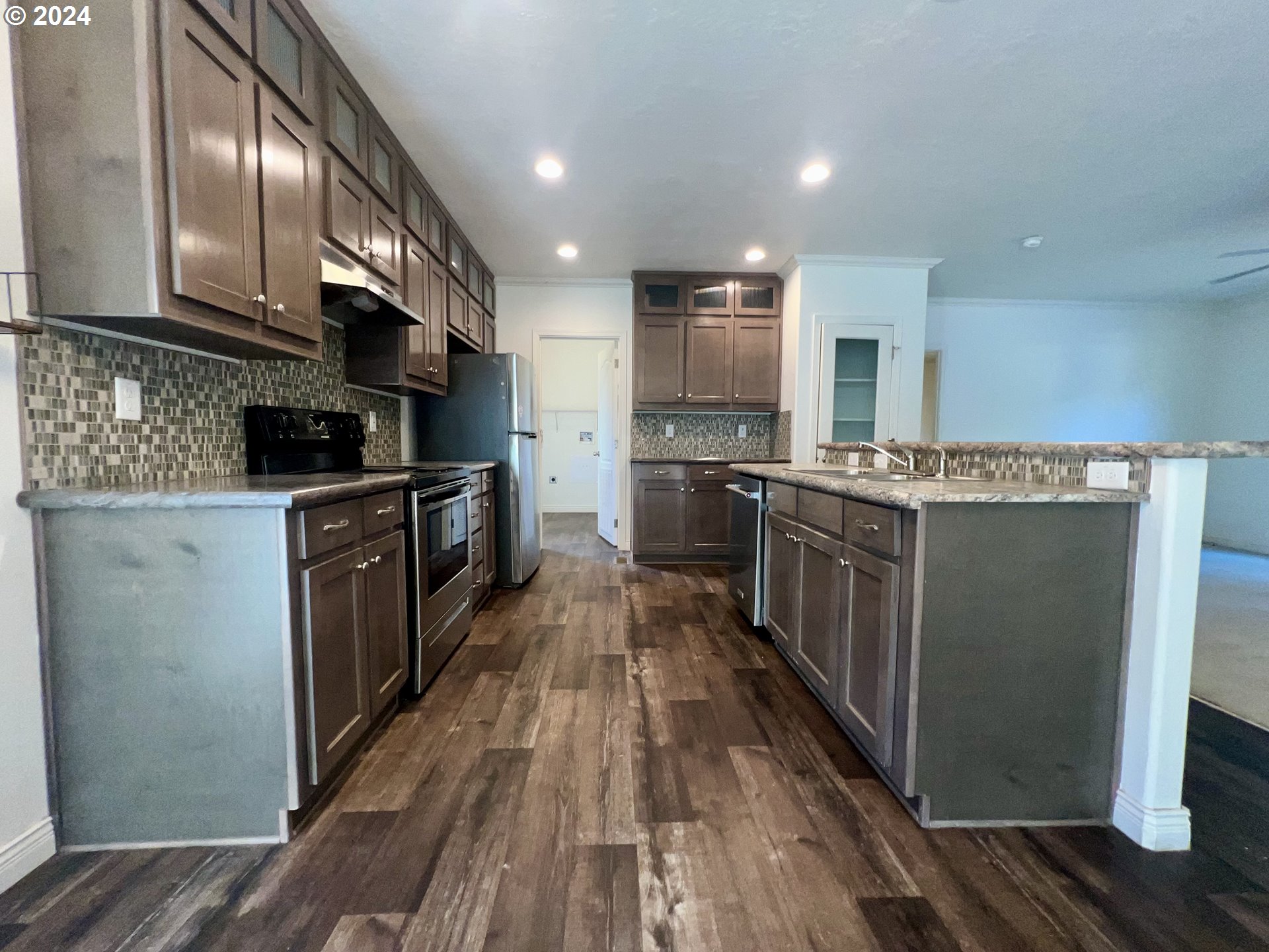 28312 Mateer Road Gold Beach, OR 97444 - Photo 10 of 25 a kitchen with stainless steel appliances granite countertop lots of counter top space and wooden floor