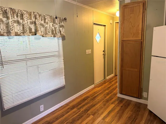 a view of a closet area with wooden floor
