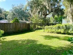 a backyard of a house with a yard and plants