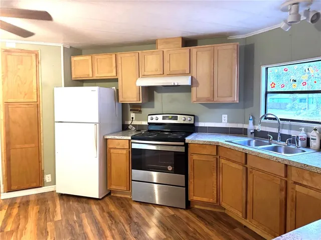 a kitchen with a stove a sink and a refrigerator